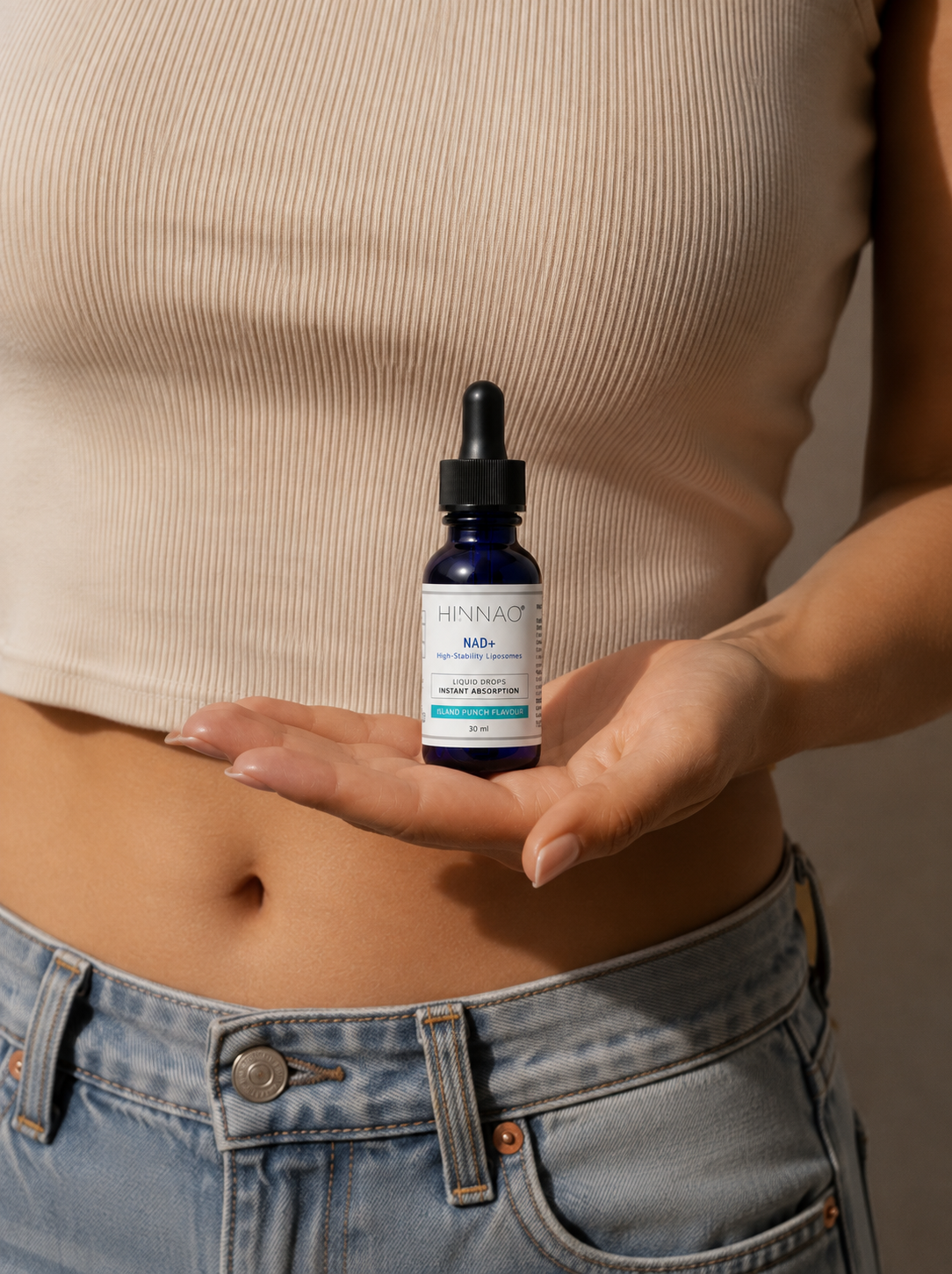 Woman holding a HINNAO NAD+ high-stability liposomal bottle in her palm